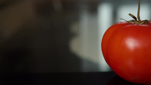 Red Juicy Tomato Lies on the Table Moving Camera