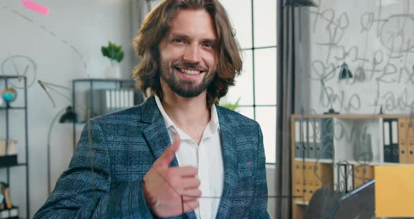 Office Worker Posing on Camera Behind Glass Board and Showing Symbol Alright in Modern Office alt