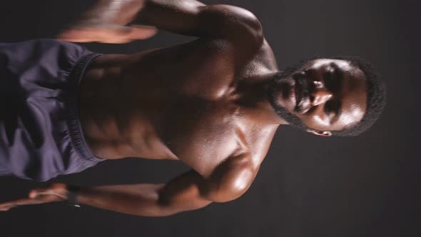 An Athletic AfricanAmerican in Good Athletic Shape is Engaged in Sports on an Isolated Dark alt