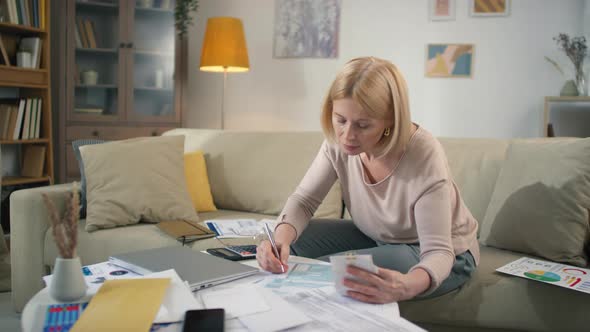 Happy Woman Filling Out Tax Return alt