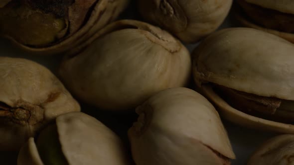 Cinematic, rotating shot of pistachios on a white surface - PISTACHIOS 010 alt
