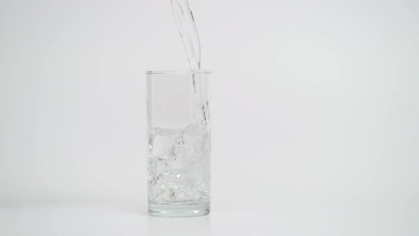 Slow Motion of Pouring Water in Glass with Ice, 1000 fps Shot alt