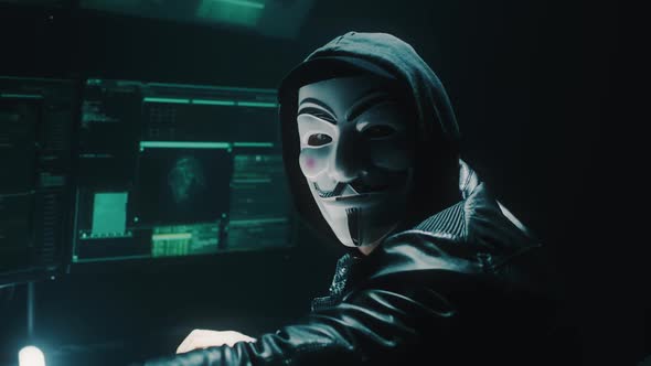 Unrecognizable Hacker Looking at Camera alt