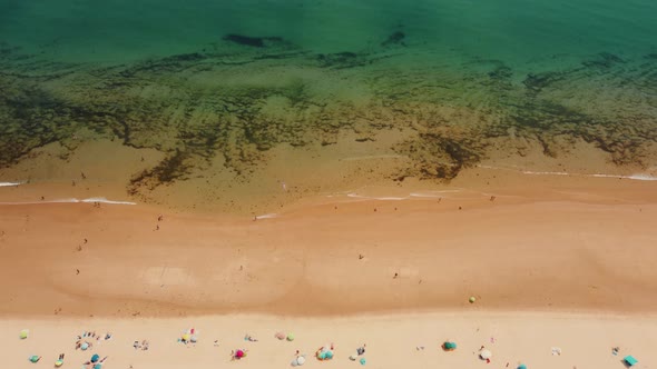 Tourist On Golden Sandy Shoreline Of Praia da Alagoa In Portugal During Summer. - Aerial Topdown alt