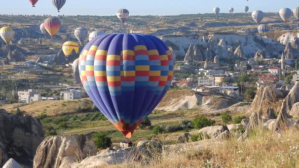 Hot Air Balloon Flying Over Hoodoos and Fairy Chimneys in Goreme Valley Cappadocia, Urgup Turkey alt