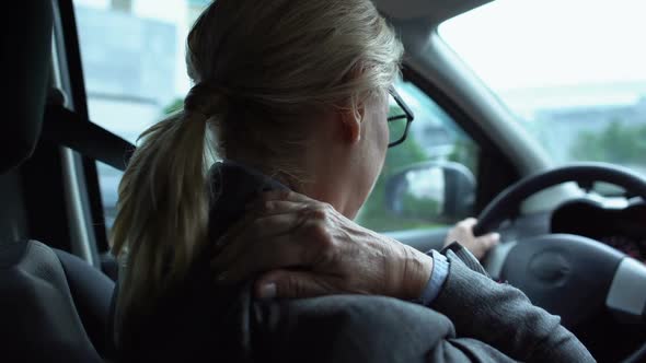 Tired Woman Massaging Numb Neck Sitting on Driver Seat of Car, Back-View