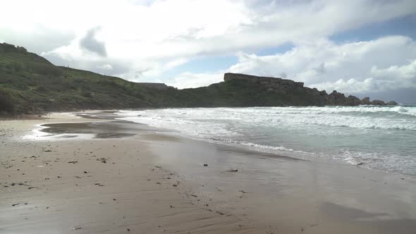 Walking on a Sandy Ghajn Tuffieha Bay Beach on Sunny Winter Day alt