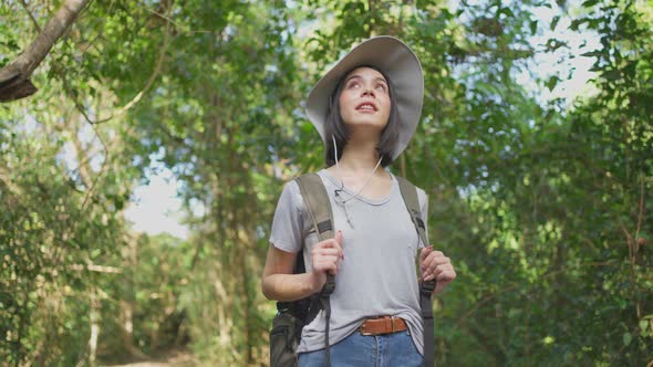 Young Caucasian woman feeling fresh and relax while traveling in the forest together on holiday trip alt