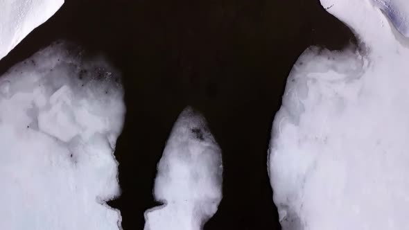 Fly over frozen Fitzgerald Pond where it meets Mullen Brook, melting the fringes. alt