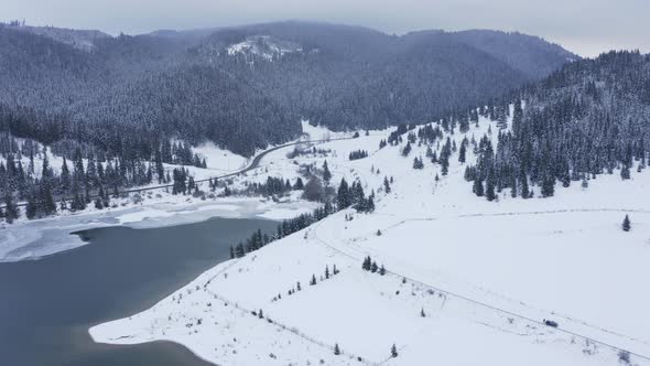 Snowy mountain landscape. Aerial descending approach alt