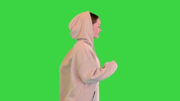 Young Woman Running in a Hoodie Running on a Green Screen Chroma Key