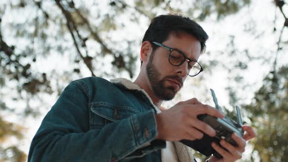 Drone Operator Boy While Pilot a Quadcopter Remote Controller alt