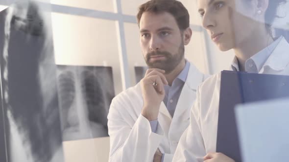 Doctors examining a patient's x-ray and discussing