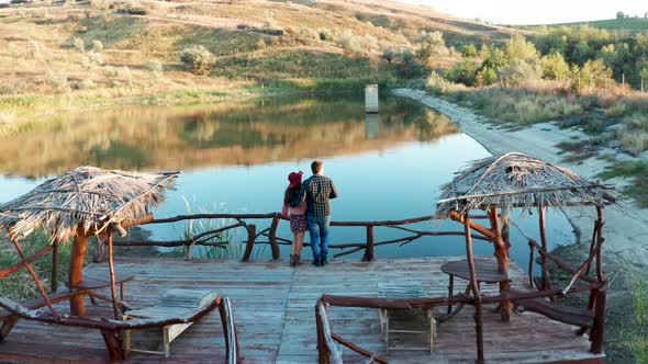 Couple on a Pontoon Bridge in a Vacation in Rural Area alt