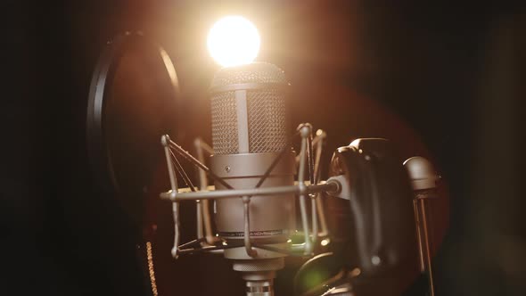 Microphone on Stage Against a Black Background With Lighting