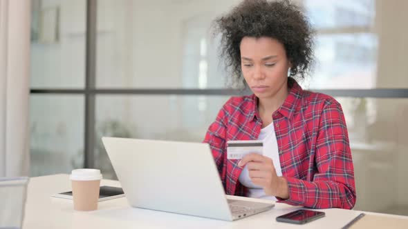 African Woman Making Online Payment Failure on Laptop alt