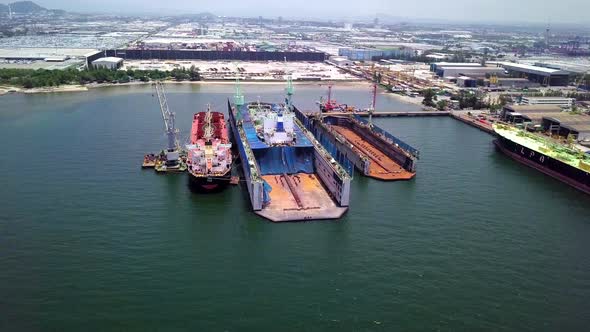 Aerial view of logistics concept a cargo ship being retrofit, repair and services on a floating dry alt