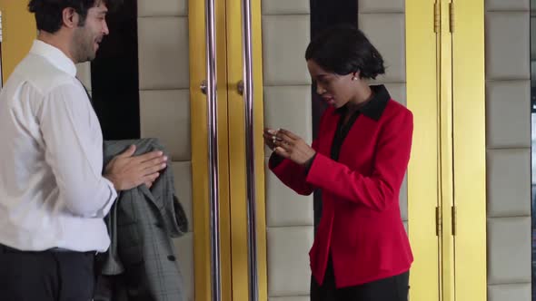 The Female Staff is Standing to Check the Ticket alt