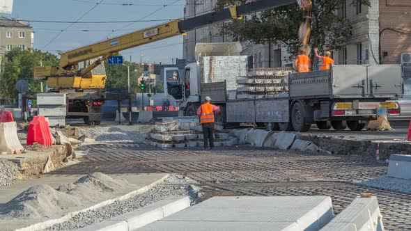 Yellow Construction Telescopic Mobile Crane Unloading Railway Sleepers From Truck Timelapse. alt