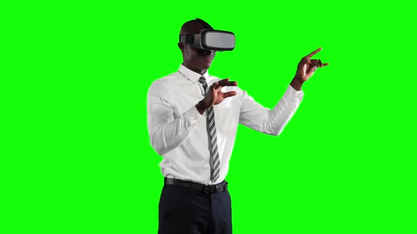 an African American man wearing 3D goggles in a green background