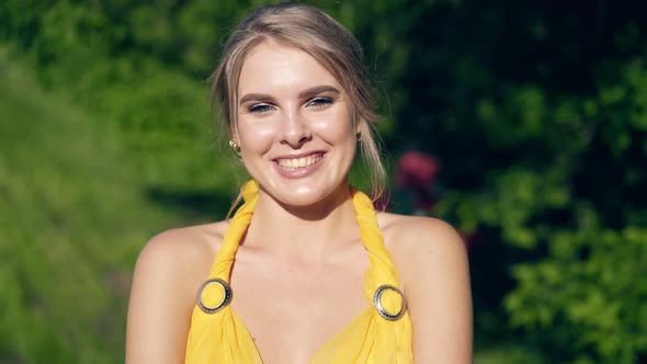 CU, Portrait: Young Beautiful Girl in Lush Yellow Evening Dress Posing Against the Trees, Smiling alt