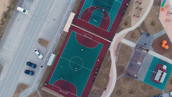 The Drone Descends on a Sports Ground in the Yard People Play on the Sports Ground in Their Free alt
