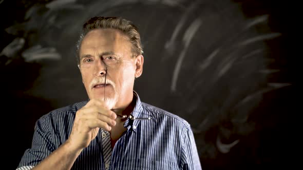 Elegant Senior Man Smiles And Feels Healthy Over The Grey Wall.