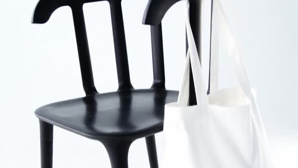 Handbag hanging on a chair alt