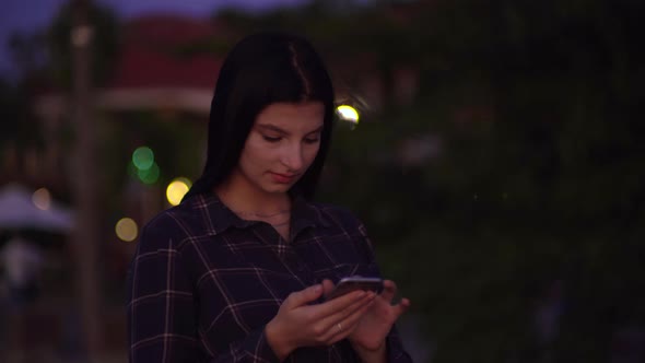 Woman Using Smartphone Walking on Street Swiping Screen Texting Blogger