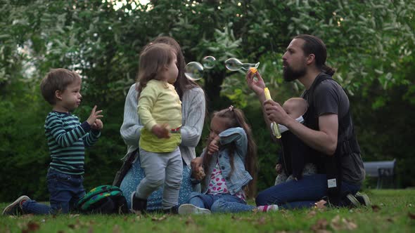 Happy Family Mother Father Three Four Baby Little Siblings Kids Have Fun Blowing Bubbles Enjoying alt