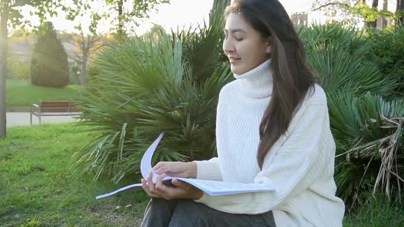 Studying Happy Young Woman Reading Her Book for School. Beautiful Mixed Race Asian Caucasian Girl.