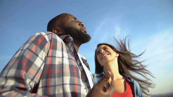 Multiracial Tourist Couple Talking Outdoors, Enjoying View From Observation Deck