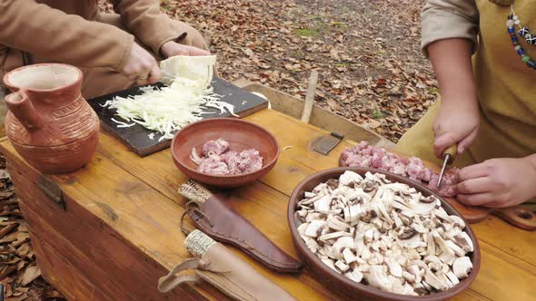Hands slicing food ingredients alt