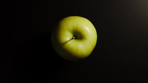Green Apple On A Black Surface