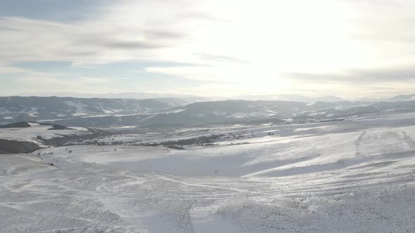 Snowy mountain landscape, aerial view of mountains at sunset near Didgori. Nichbis alt