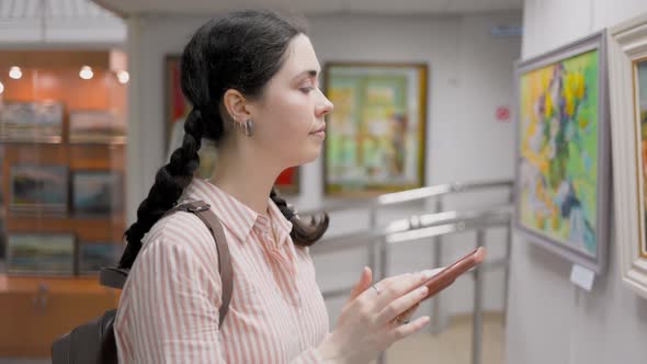 Culture and education. Portrait of smiling caucasian woman using a smartphone. Virtual excursion alt