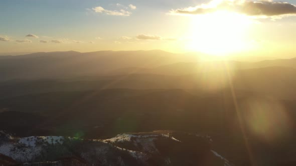 Aerial view at the mountain on a sunset of the winter day