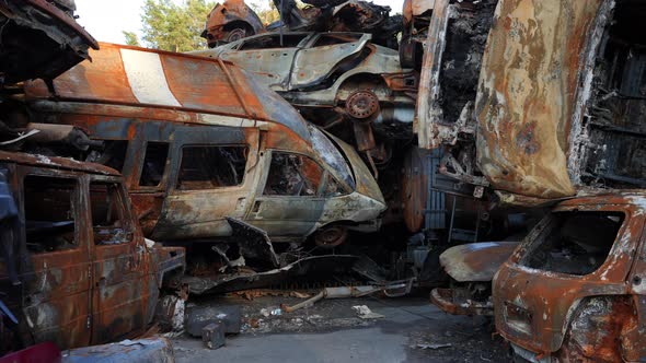 Live Camera Entering Car Dump with Burnt Down Automobiles Outdoors alt