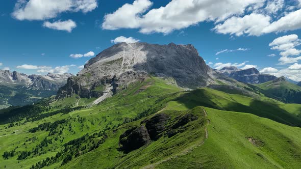 Dolomites mountains peaks with a hiking path on a summer day alt