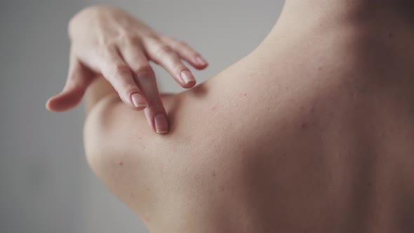 Female Shoulders Close Up. Girl Touches Her Neck and Shoulders alt