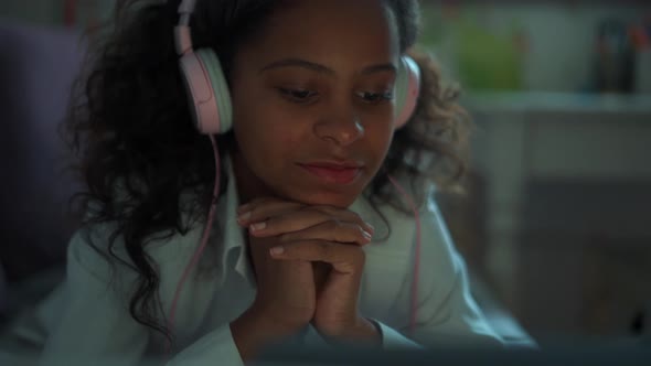 Pretty girl watching something on laptop alt