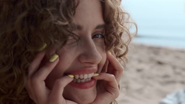 Closeup Woman Face Laughing Camera in Front Sea Waves alt