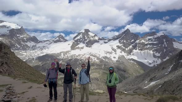 Tourists on a Pass in the Alps alt