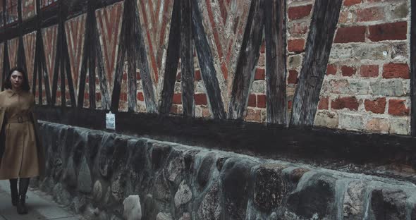 Fashionable Woman Walking In Old Town alt