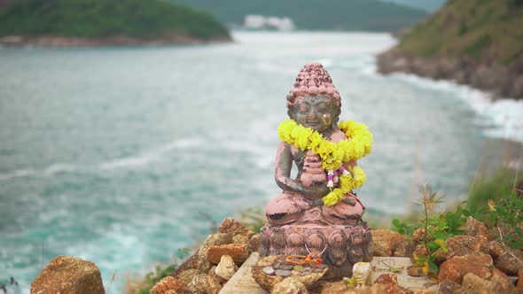Statue of A Deity with A Garland of Yellow Flowers, Close-Up. Tranquility and Harmony Atmosphere alt