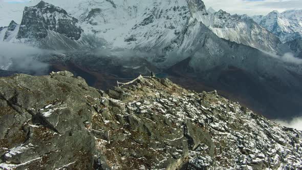 Hiker Man on Top of Nangartsang and Ama Dablam Mountain. Nepal. Aerial View alt