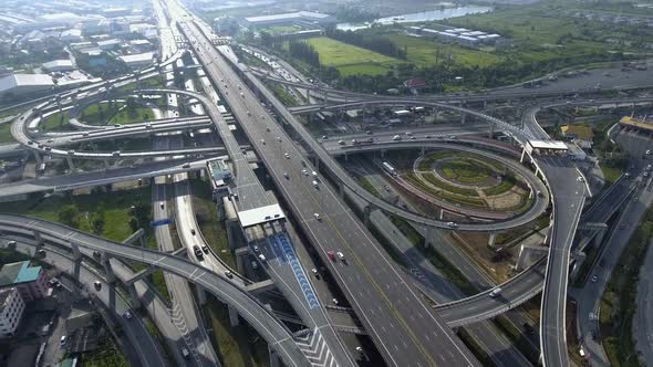Aerial View of Highway Road Interchange with Busy Urban Traffic Speeding on Road alt