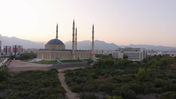 Top View of Blue Mosque Minaret and City Skyline with Mountains in the Background alt