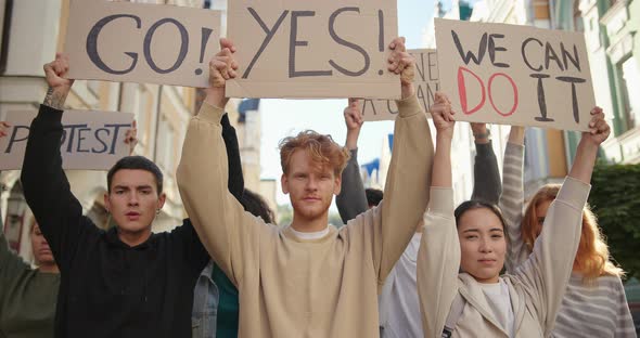 Silent Protest Multiracial Student Activists with Posters at City Streets alt