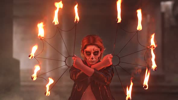 Creepy Bride with Makeup on Her Face Holding Burning Torches. Halloween. alt